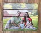 Family of four sitting on the grass photo on a four plank wood photo pallet