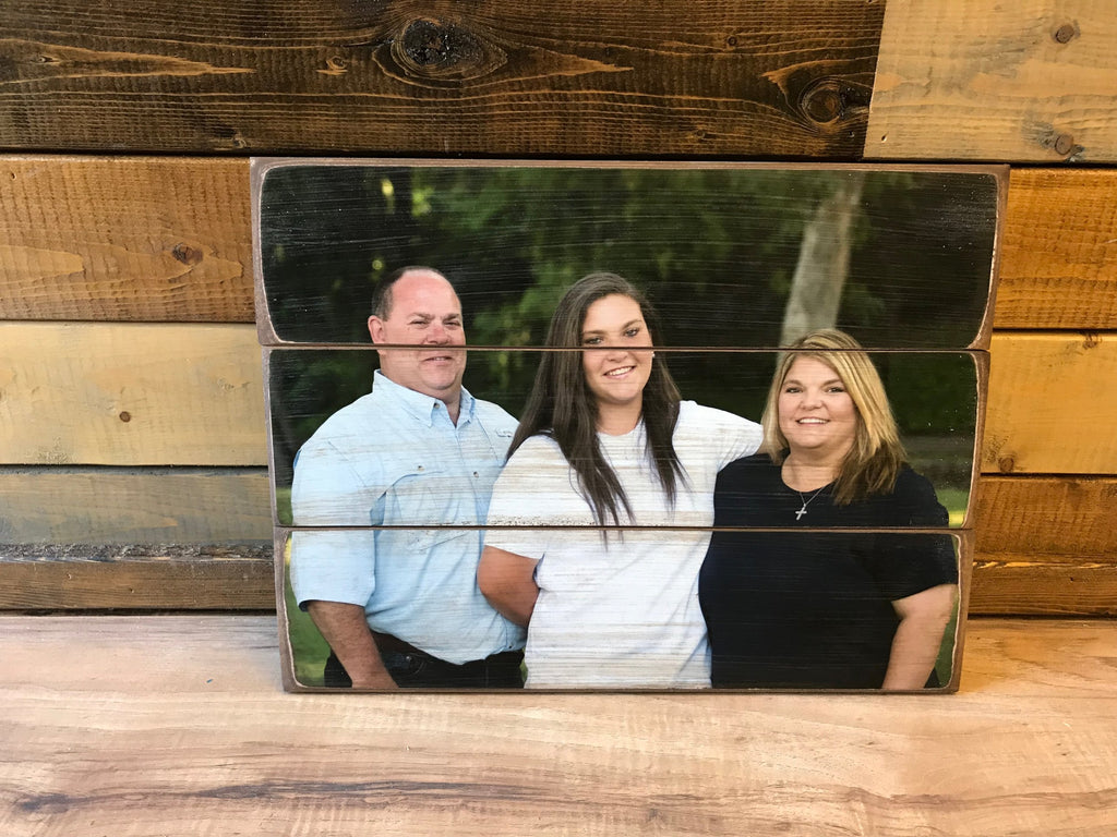 Parents and daughter family portrait on a three plank wood photo pallet