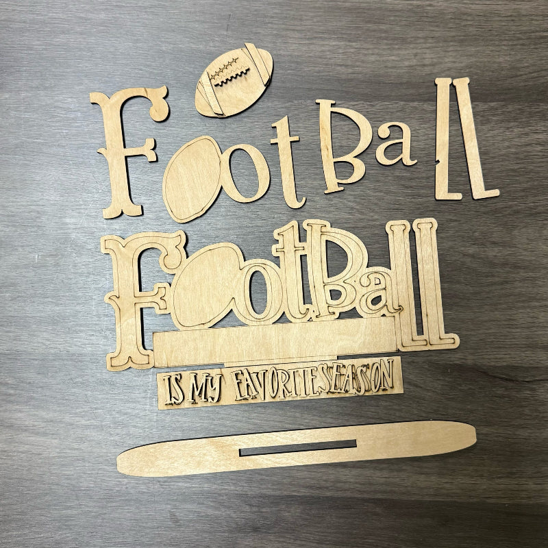 Wooden decorative signs with 'Football' text and football graphics on a wooden surface